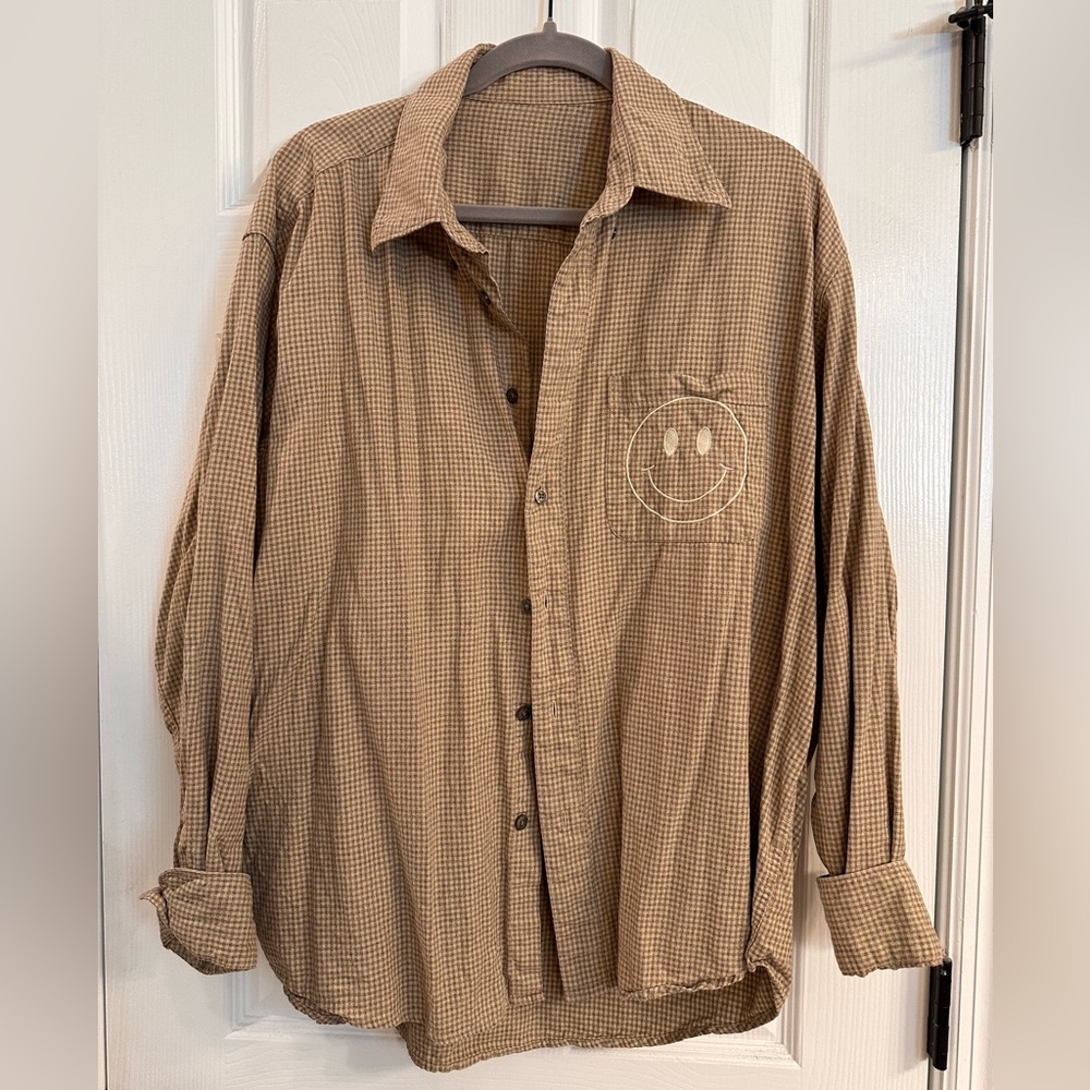 Reworked flannel with smiley face stitched on pocket